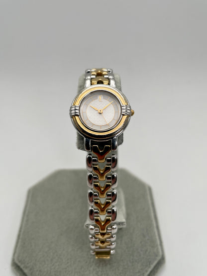 Front view of Yves Saint Laurent vintage women's watch showing the full dial with gold-tone hands and logo at 12 o'clock
