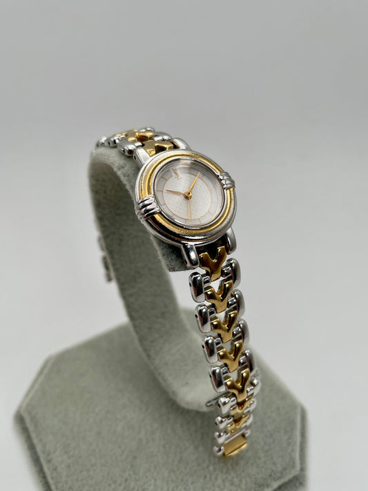 Main view of Yves Saint Laurent vintage women's watch in round gold and steel case with textured white dial and two-tone Y-link bracelet
