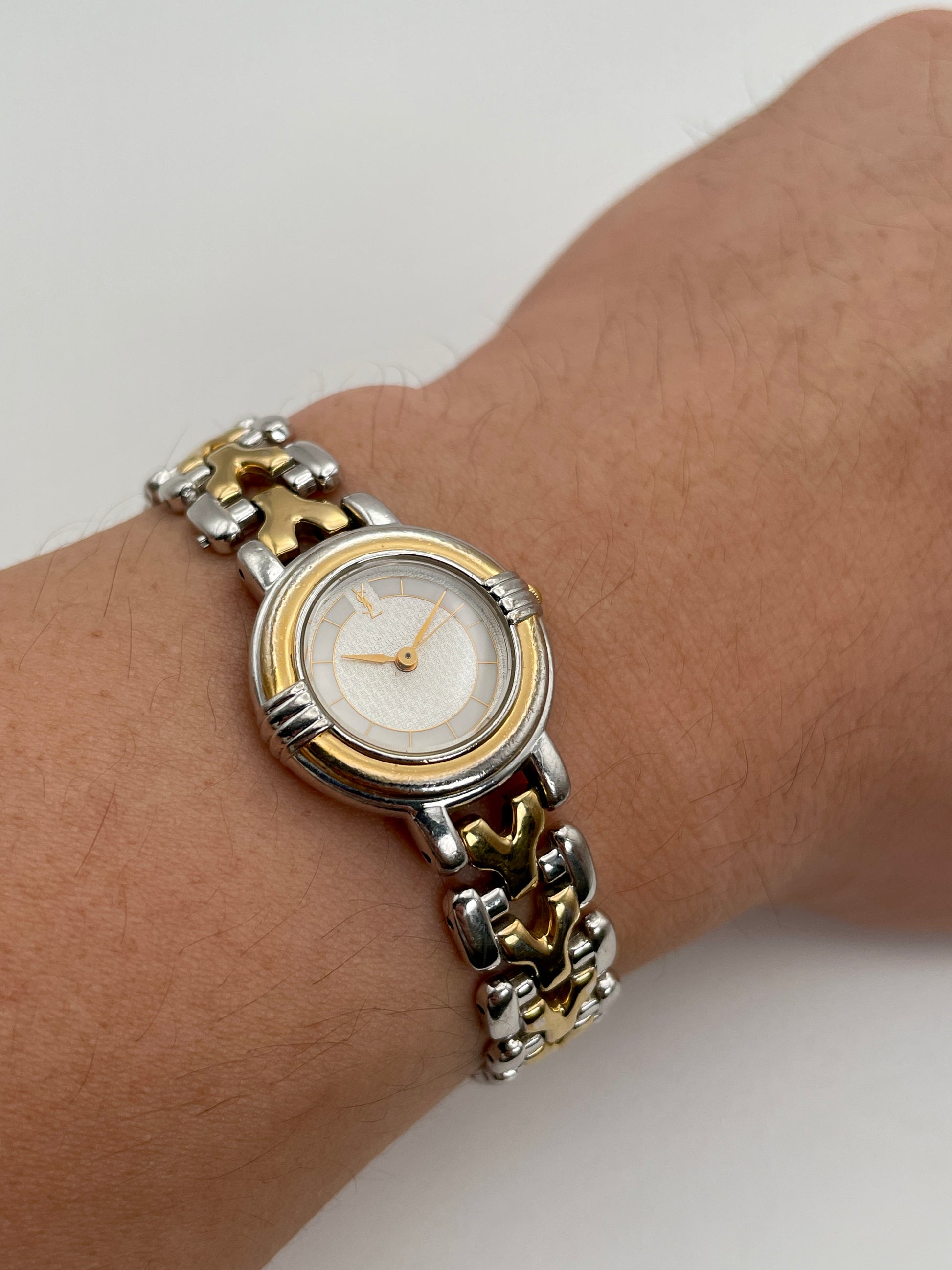 Wrist shot of Yves Saint Laurent vintage women's watch showing its size and how it wears on the wrist
